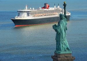 Cunard Cruises Queen Mary 2 arriving in New York City under Statue of Liberty
